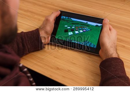 Prague, Czech Republic - March 16, 2019: Man Holding A Smartphone And Playng The Minecraft Mobile Ga