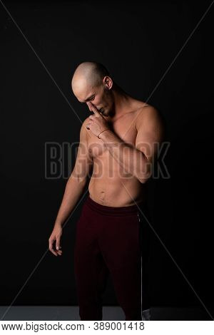 A Man Holds His Nose Pumped On A Black Foon