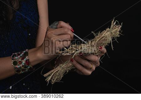 Portrait Of Witch Holding 
Voodoo Doll In Hand  On Dark Background. The Wich Is Cursing; Astrology, 