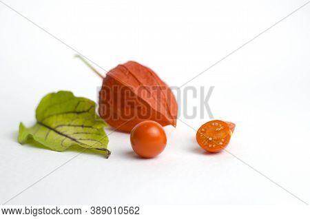 Physalis On A White Background. Ripe Berry In A Shell, Physalis Leaf, Physalis Berry Without A Shell