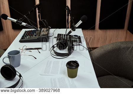 Working Place Of Radio Host. Close Up Of Microphones, Headphones, Sound Mixing Desk, Script On The T