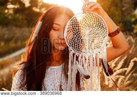 Beautiful Boho Woman In A Sunny Field At Sunsrt.