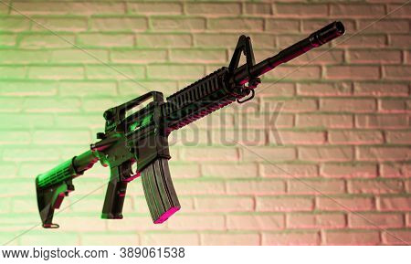 American Army Rifle M4a1 Against A Brick Wall