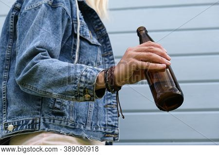 A Brown Bottle Of Beer In A Hand Of Punk, Informal Woman, Alcohol Addiction, Overdosage And Abuse Co