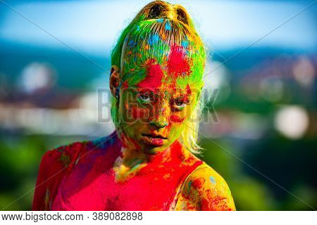 Color Face With Colorful Holi Splash. Close-up Portrait Of A Young Woman With Colorful Holi Powder. 