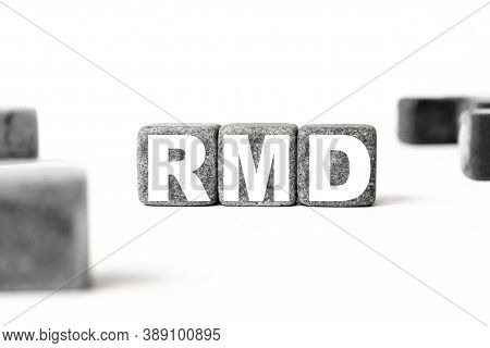Three Stone Cubes Inscribed With The Word Rmd Required Minimum Distributions Among The Cubes On A Wh
