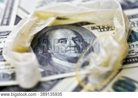 Used Condom With Cum And Us Dollars Bills. Prostitution Concept. Pay For Sex Per Night. Harlotry And