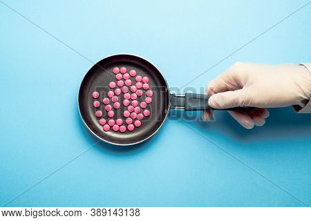 Abstract Drug Making Concept With Frying Pan And Pills.