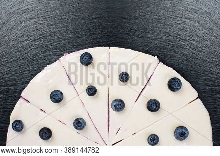 Curd Cake With White Icing And Wineberry.