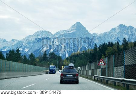German People And Foreign Travelers Driving Car On The Highway Road Go To Tirol City In Biberwier, A