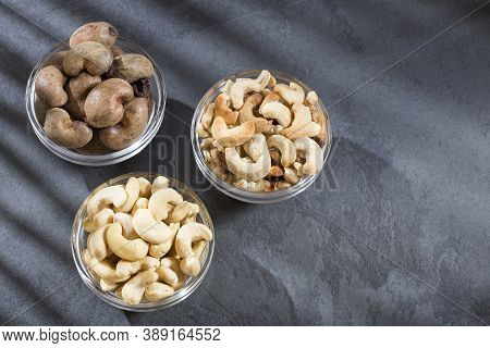 Natural And Roasted Cashew Nut On Wooden Background - Anacardium Occidentale