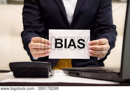 The Word Bias Is Written On A White Piece Of Paper Held By A Business Woman. Personal Opinions Preju