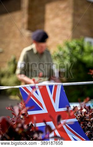 Ackworth, Uk - May 08, 2020: A Soldier Clad In Old Uniform Come Out From  His House To Celebrate 75t