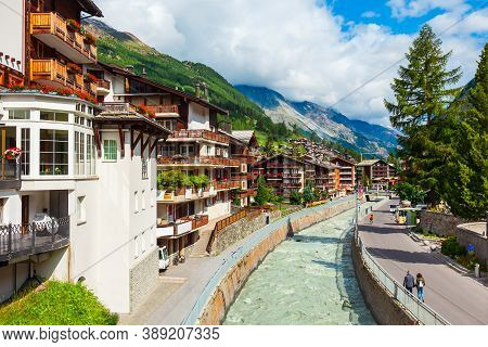 Traditional Local Houses Near The Matter Vispa River In The Centre Of Zermatt Town In The Valais Can