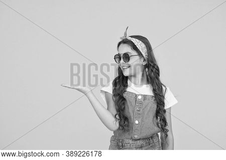 Retro Girl Presenting Product. Small Kid Wear Summer Outfit. Cheerful Child Has Vintage Look. Headke
