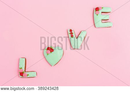 Gingerbread Heart, Cookies In Shape Of Letter Love With Icing On Pastel Pink Background. Valentines 