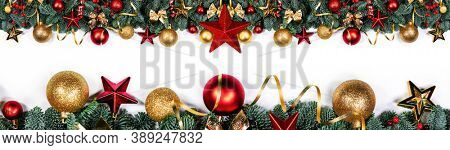 Christmas border frame design copmosition of noble fir tree branch and red golden decorations baubles isolated on white background