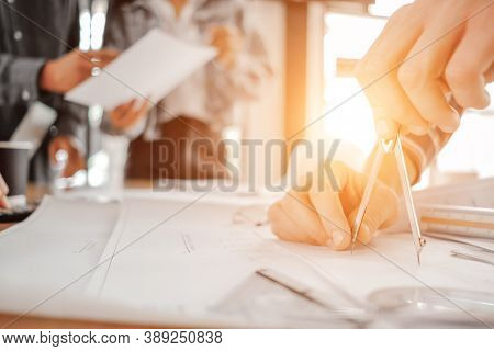 Engineers Pointing To Building On Blueprint To Drawing Design Building Project In Office, Constructi