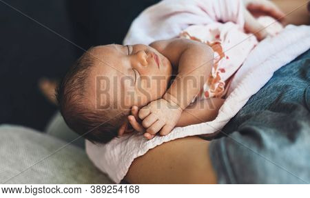 Caucasian Newborn Baby Is Sleeping While His Parents Is Holding Him Keeping In Safe