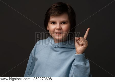 Portrait Of Serious Boy 10-12 Years Old In Casual Clothes Showing Index Finger, Scolding Or Telling 