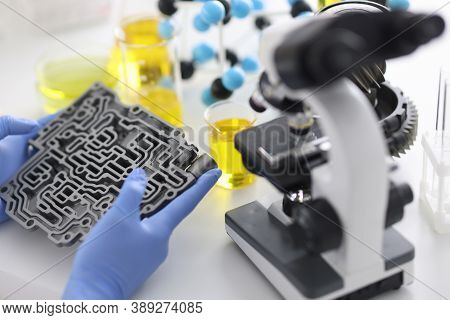 Automatic Transmission Lies In Rubber Gloves On Table With Microscope And Test Tubes In Chemical Lab