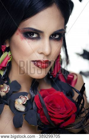 Pretty Brunette Woman With Rose Jewelry, Black And Red, Bright Make Up Kike A Vampire Closeup Red Li
