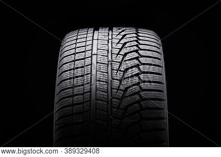Winter Tire Front View. Asymmetric Tread Pattern. Re-inflating Tires For The Season. Close-up Black 