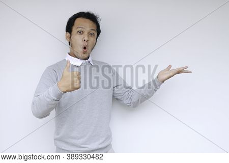 Young Asian Man Waer White Shirt Is Surprised And Shouting Wow With Pointing Right With His Finger I