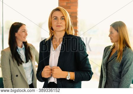 Successful Blondine Business Woman In The New Office Against Her Colleagues On Blurred Background. P