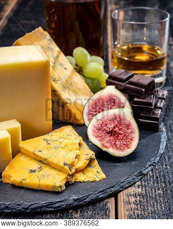 British Matured Yellow Cheese Blue Shropshire, Smoked Cheddar And Fresh Figs Close Up