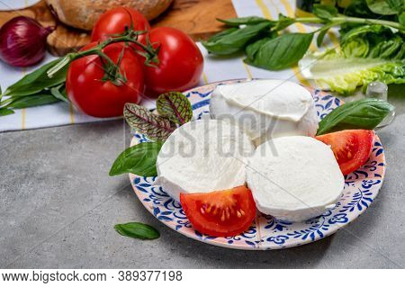 Making Of Fresh Caprese Salad With Soft Italian Cheese From Campania Buffalo Mozzarella With Ripe To