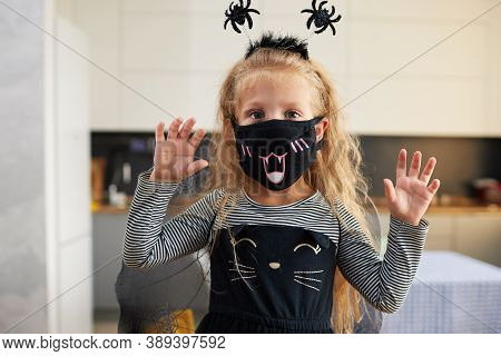 Funny Child Girl Dressed In Witch Canival Costume. Halloween Holiday During Quarantine Time
