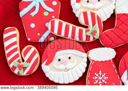 Christmas Cookies With Santa Face On Red Fur Background 