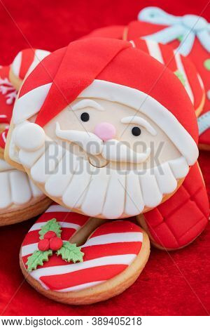 Christmas Cookies With Santa Face On Red Fur Background 