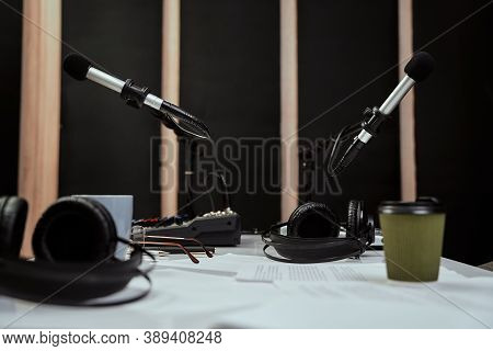 Working Place Of Radio Host. Close Up Of Microphones, Headphones And Sound Mixing Desk On The Table 