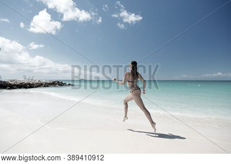 Woman Runing With Beautiful Body In Swimsuit Running In Ocean Water Sunny Day At Tropicl Beach, Spor