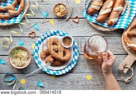 Celebrating Oktoberfest Alone. Traditional Food And Beer, Top View On Wooden Table,