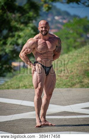 Powerful Muscular Bodybuilder In Panties Posing At The Park.  Quadriceps Contraction