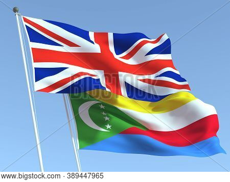 Two Waving State Flags Of United Kingdom And Comoros On The Blue Sky. High - Quality Business Backgr