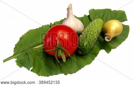 Fresh Red Tomato Cucumber Onion And Garlic On A Green Leaf On A White Background