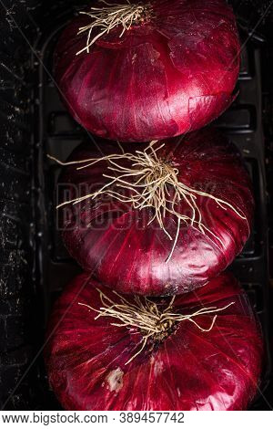 Farm Red Onions  In Tray On  Old Oak Wooden Table. Close Up Top View.