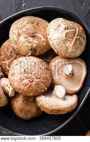 Shiitake Mushrooms Set On Black Background Top View Close Up.