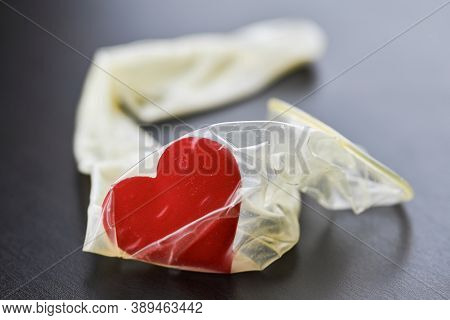 Heart In Used Condom. Sex Love Concept. Intercourse After A Date At Hotel. Birth Control And Sexual 