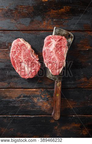 Flat Iron Steak, Raw Meat, Marbled Beef Top Blade Chuck Cut On Metal Butcher Cleaver Knife Top View
