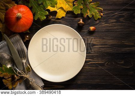 Autumn Table Setting With Craft Plate, Silverware And Fall Decorations. Dark Wooden Table, Toned Ima
