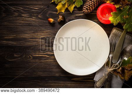 Autumn Table Setting With Craft Plate, Silverware And Fall Decorations. Dark Wooden Table, Toned Ima
