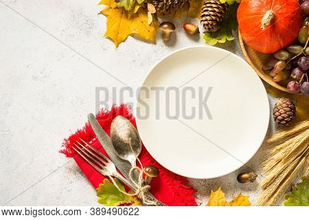 Autumn Table Setting With Craft Plate, Silverware And Fall Decorations At White Table. Thanksgiving 