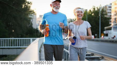Happy Senior People Running To Stay Helathy And Lose Weight