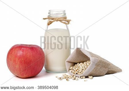 Glass Bottle Milk And Red Apple With Seed Millet In Hemp Fabric Bag Isolated On White Background. Is