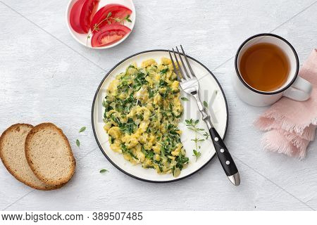 Scramble Eggs With Kale And Cheese On A Light Gray Background, Top View. Delicious Homemade Breakfas
